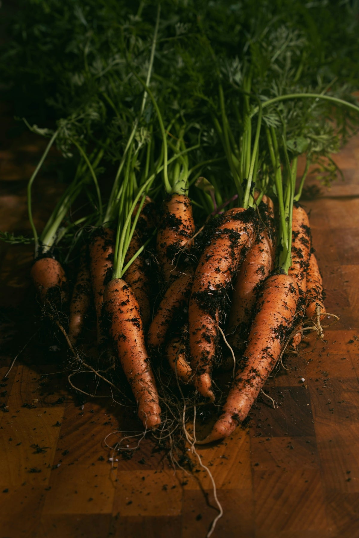 a pile of carrots sitting on top of a wooden table